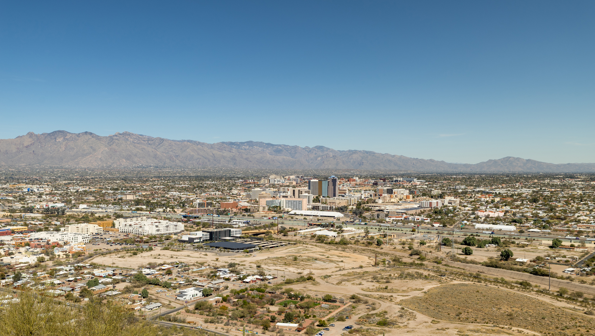 A bird's eye view of Tucson, with mountains in the distance.
