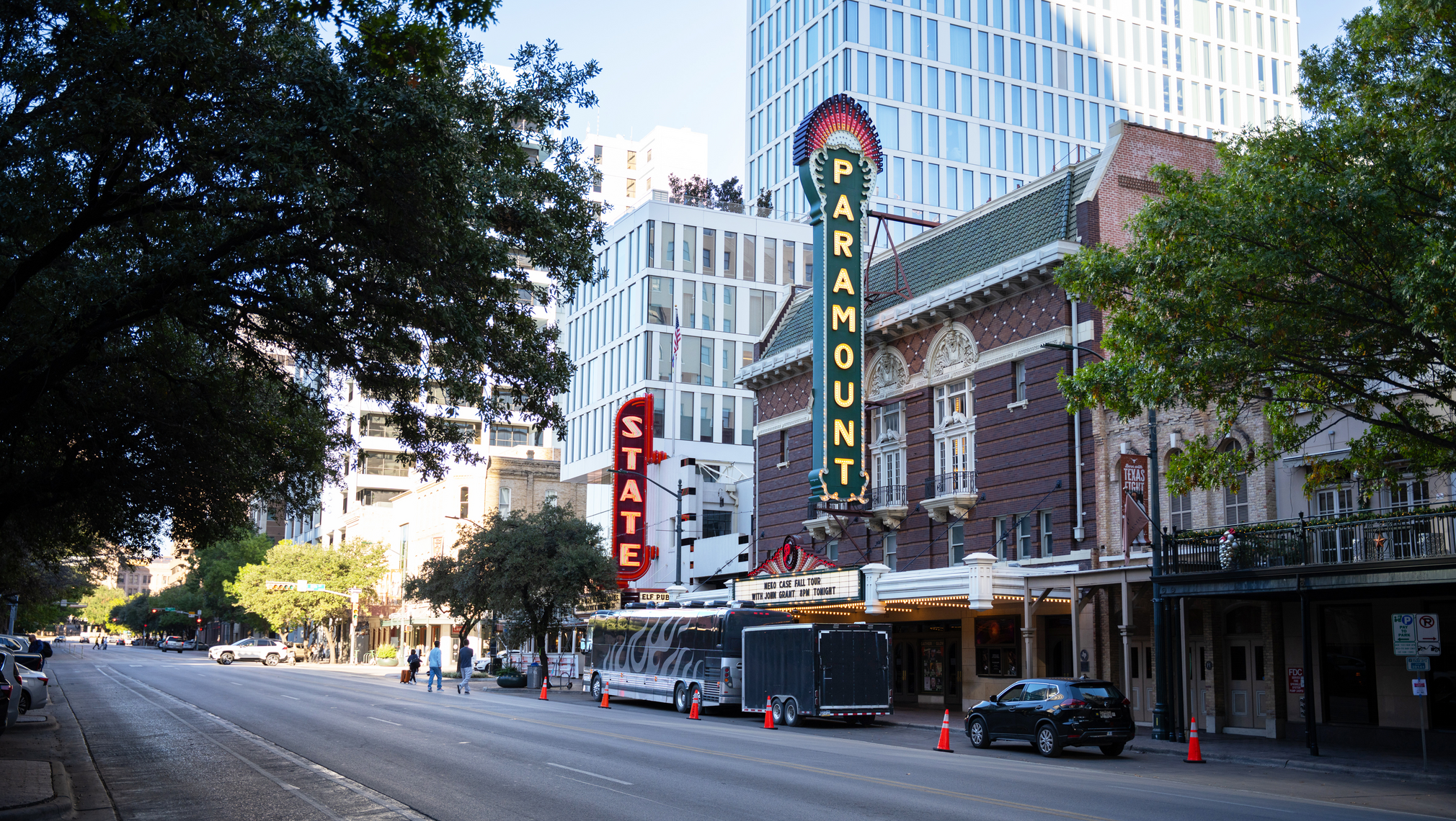 A street view of Congress Avenue in Austin, with marquees lit above venues.
