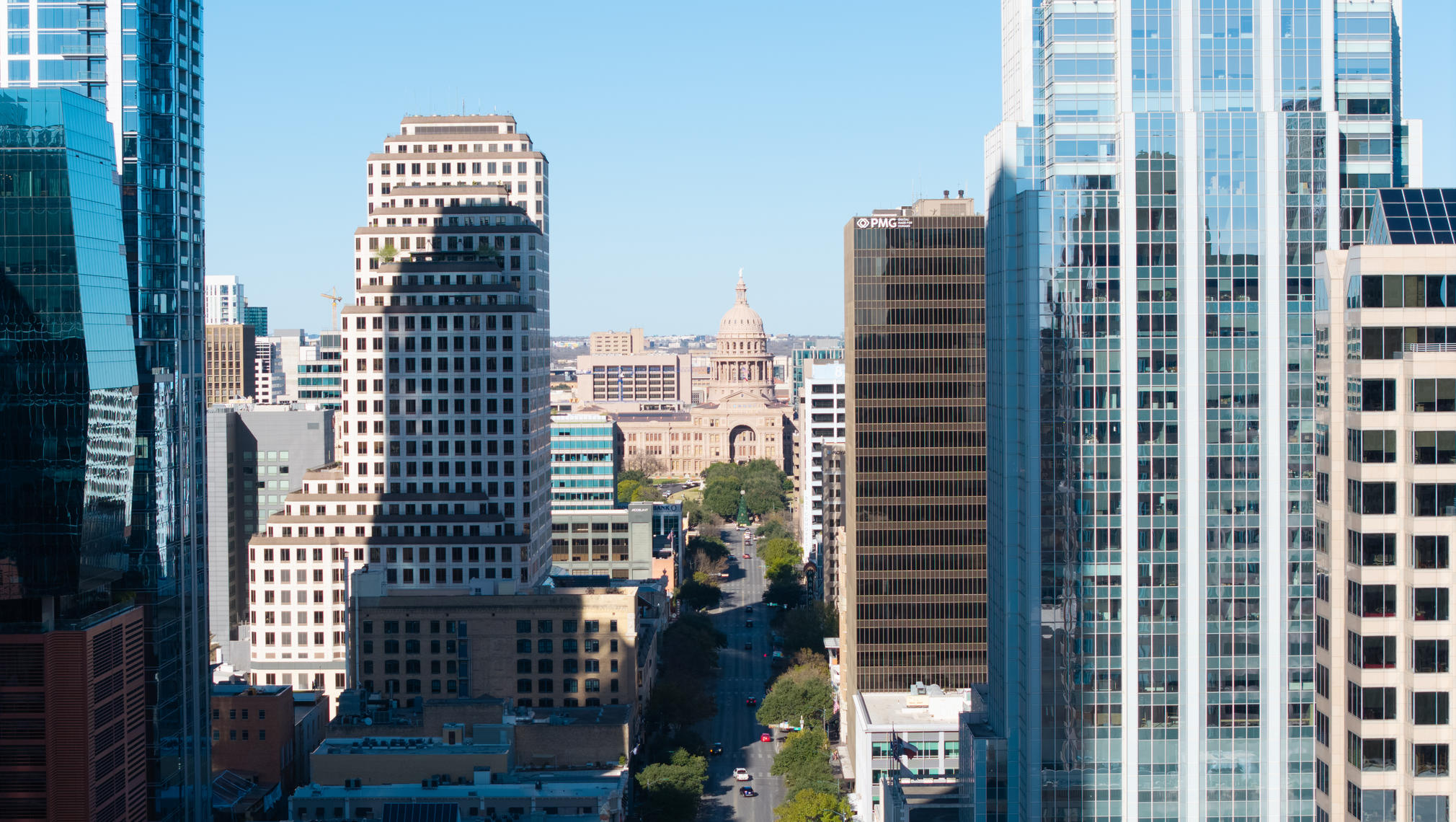 A bird's eye view of Congress Avenue in Austin, with the Texas State Capitol in the distance.