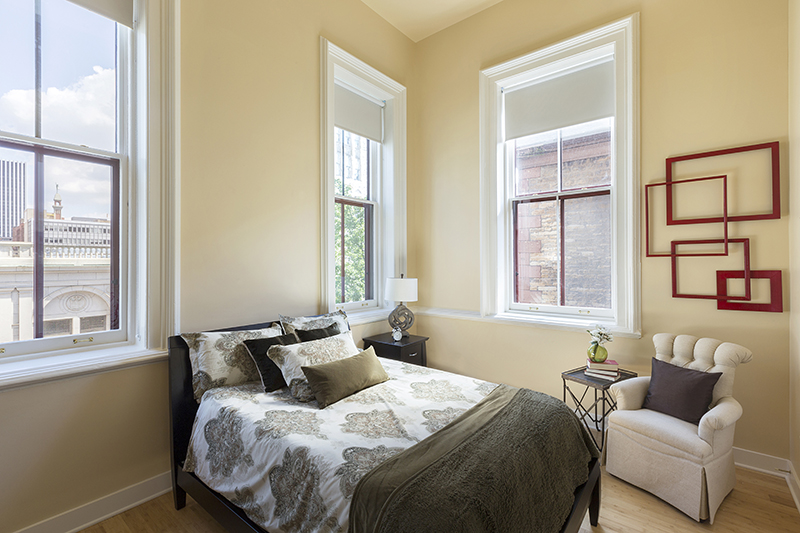Bed and armchair in bedroom