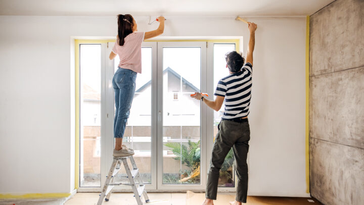 A couple touching up the edges in their new home.