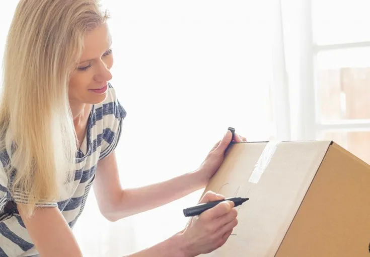 Person labeling a box