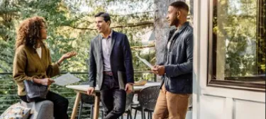 Real estate professionals discussing home details with clients