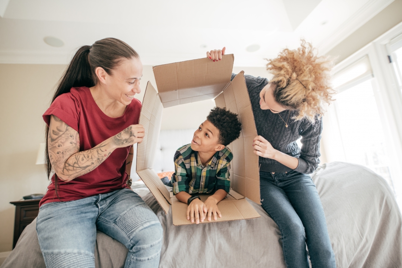 two women and a child settling into a new apartment