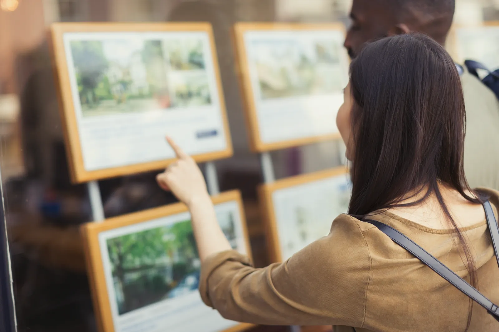 A couple of buyers looking at real estate flyers.