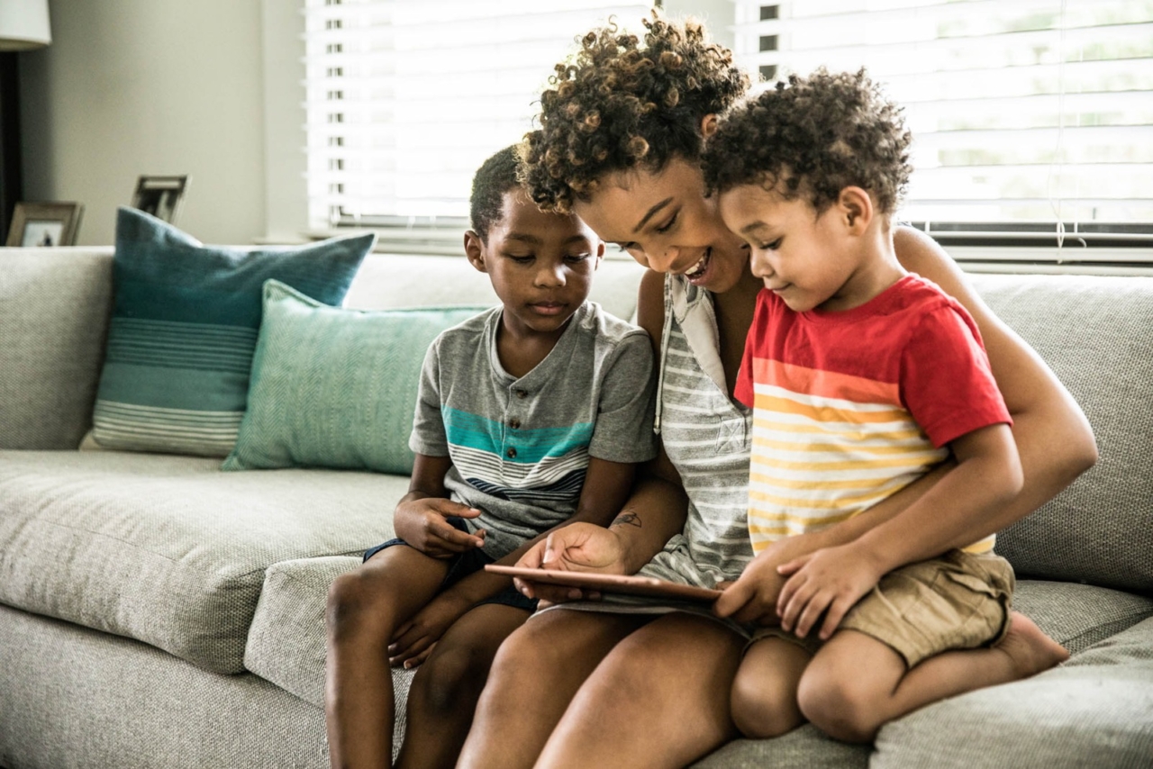 Family looking at a tablet device together