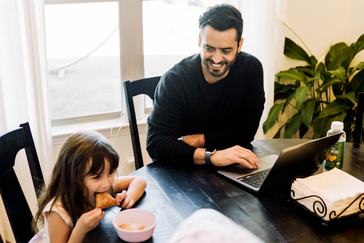 Agent Tony at his computer with a child