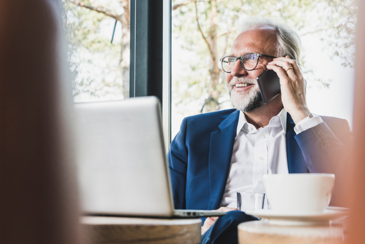 An agent on the phone with a real estate buyer lead.