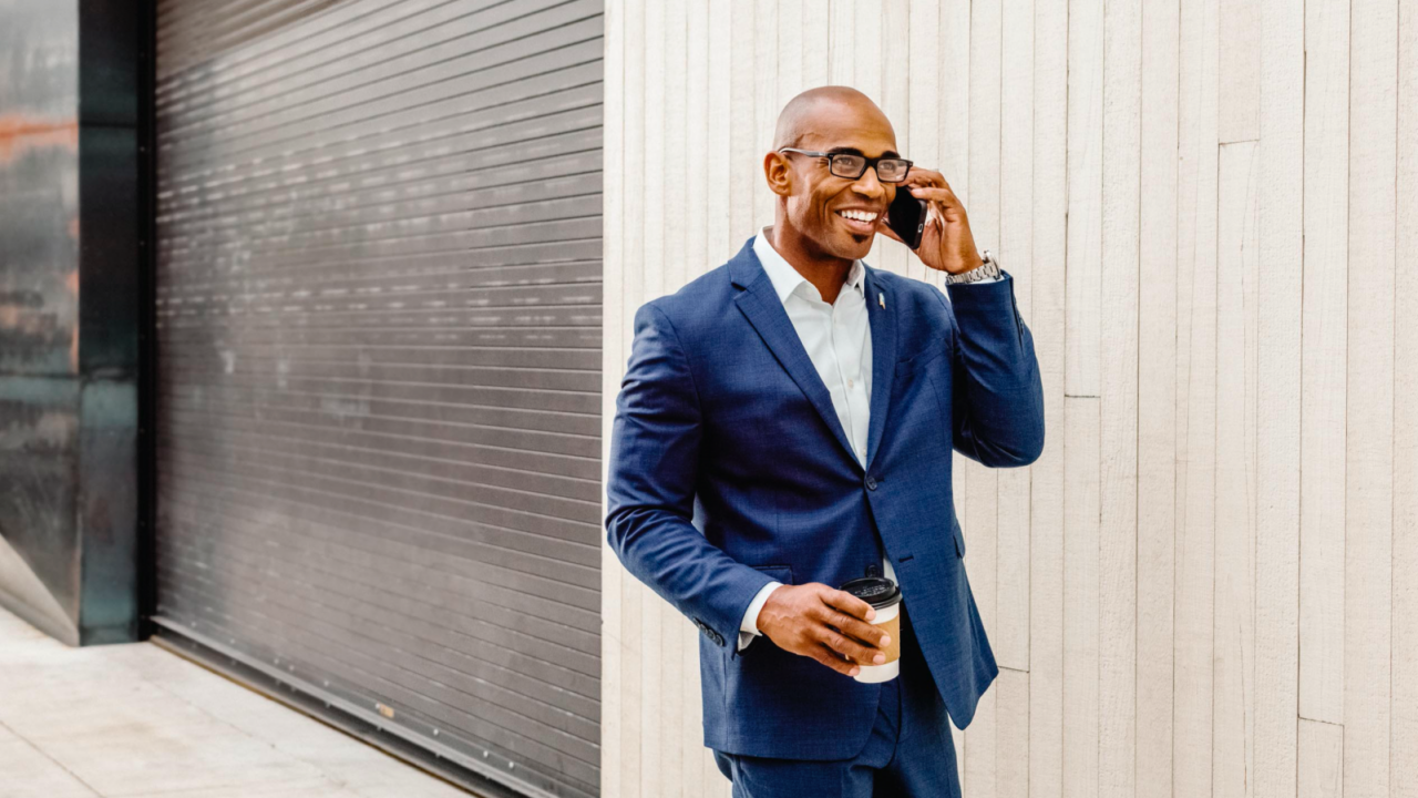 Agent in suit talking on mobile phone and smiling