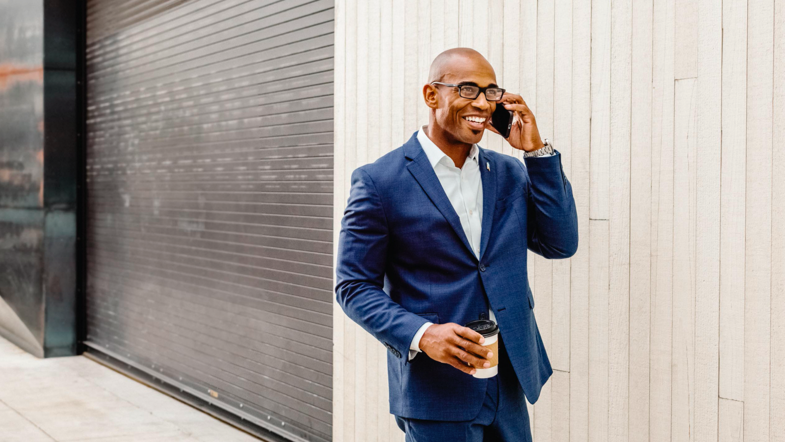 Agent in suit talking on mobile phone and smiling