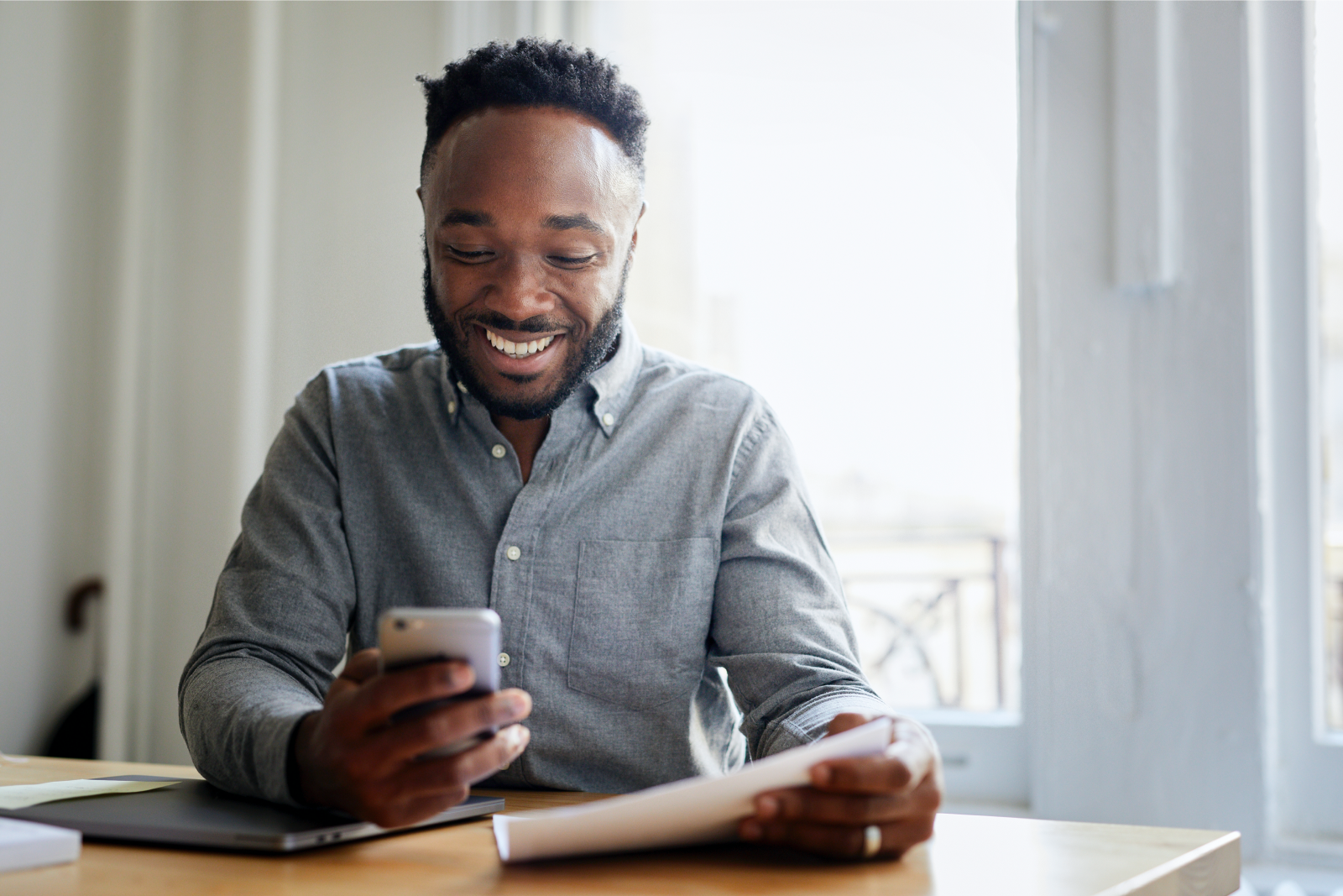 Man smiling and looking at his phone