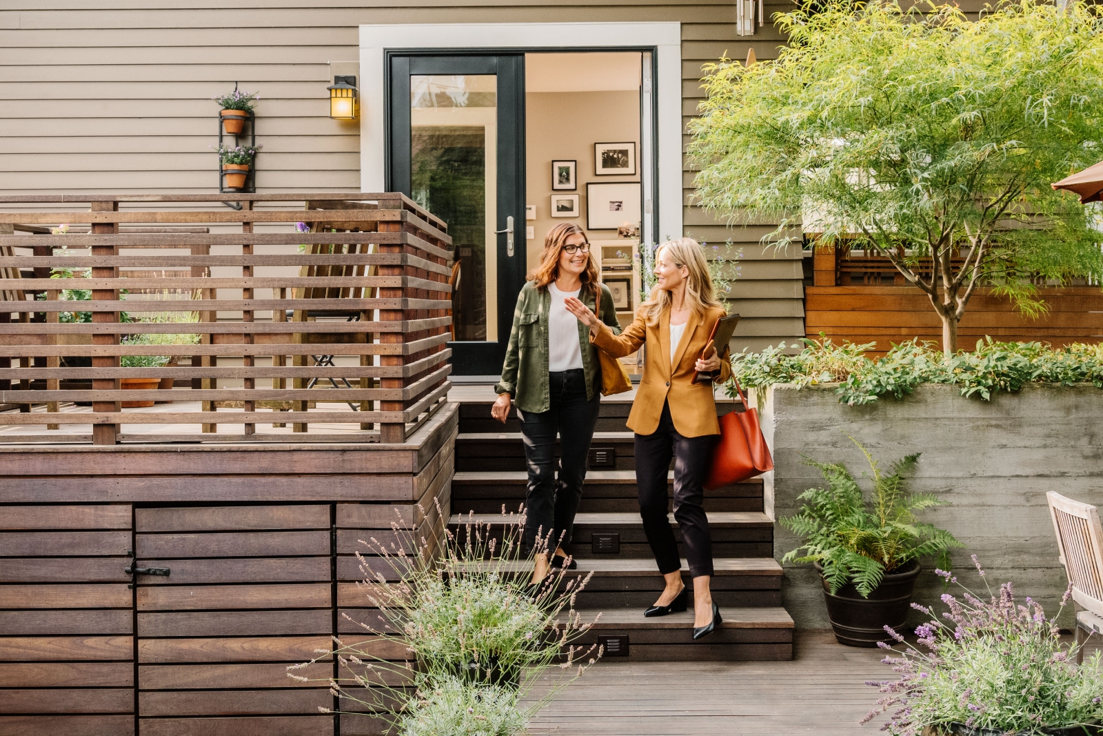 Home buyer and real estate agent leaving a home.