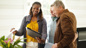 woman shows packet to couple