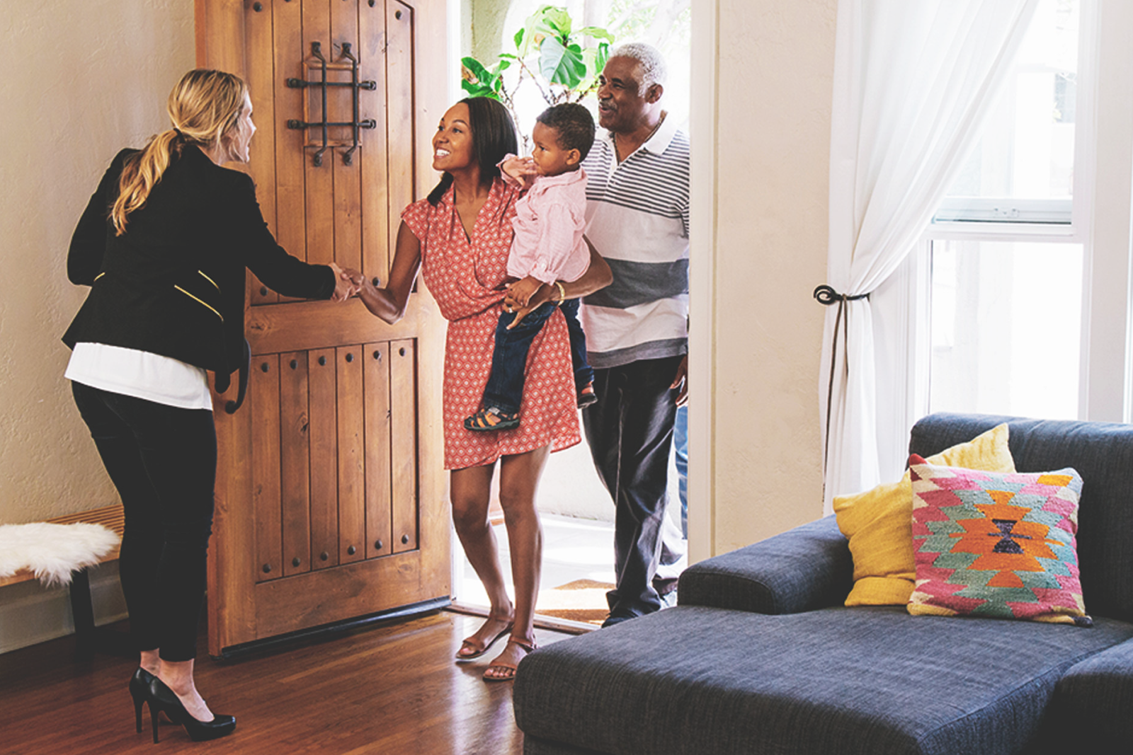 An agent welcome her real estate referrals into a home she is selling.