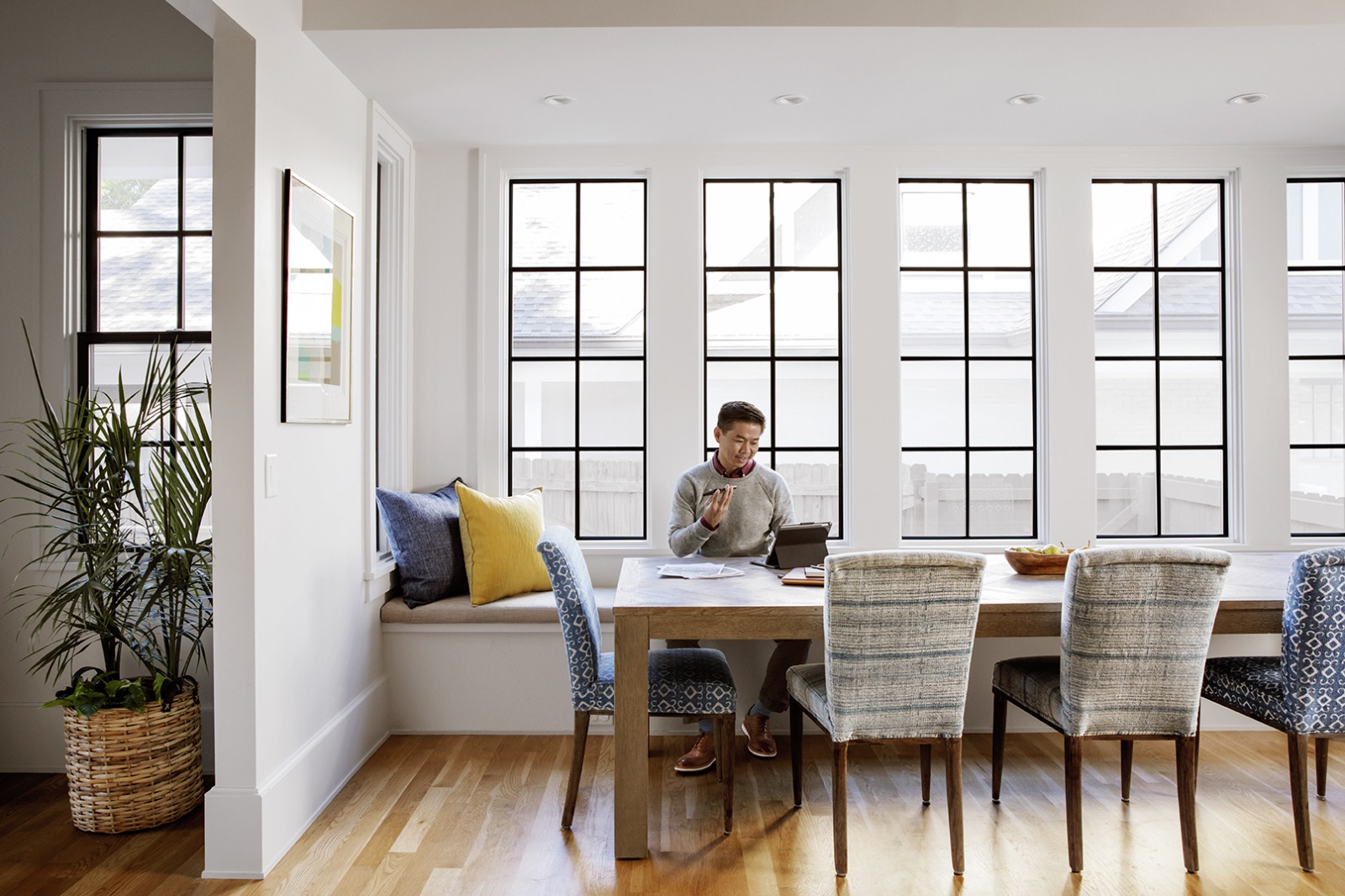 An agent multitasks on two devices at the dining table