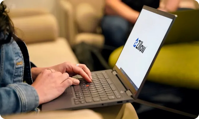 person looking at zillow on laptop