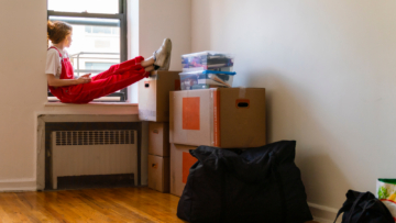 woman sitting on window sill