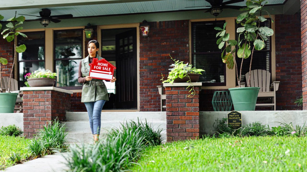 agent with home for sale sign