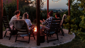 people sitting outside near fire pit