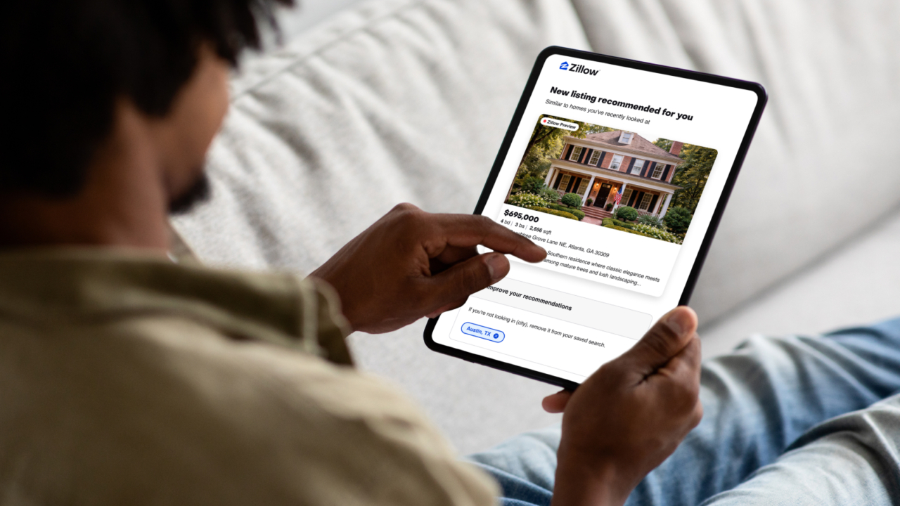 person using zillow preview on their tablet