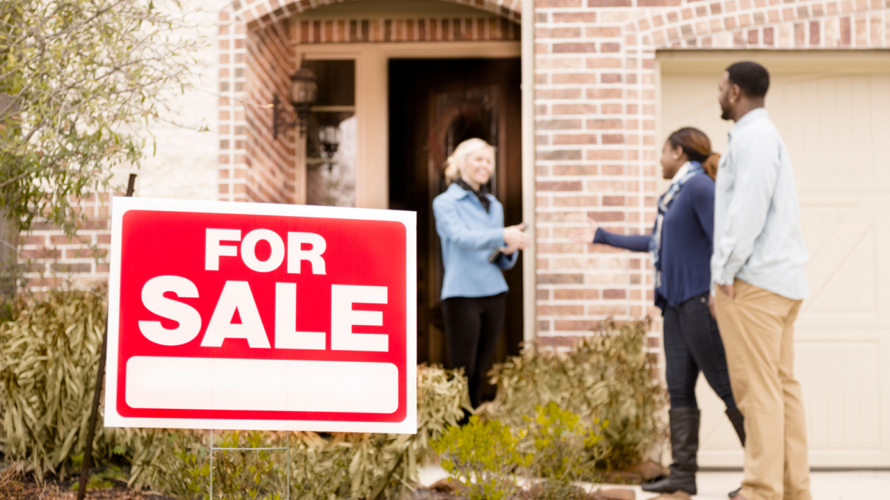 people outside of a home for sale